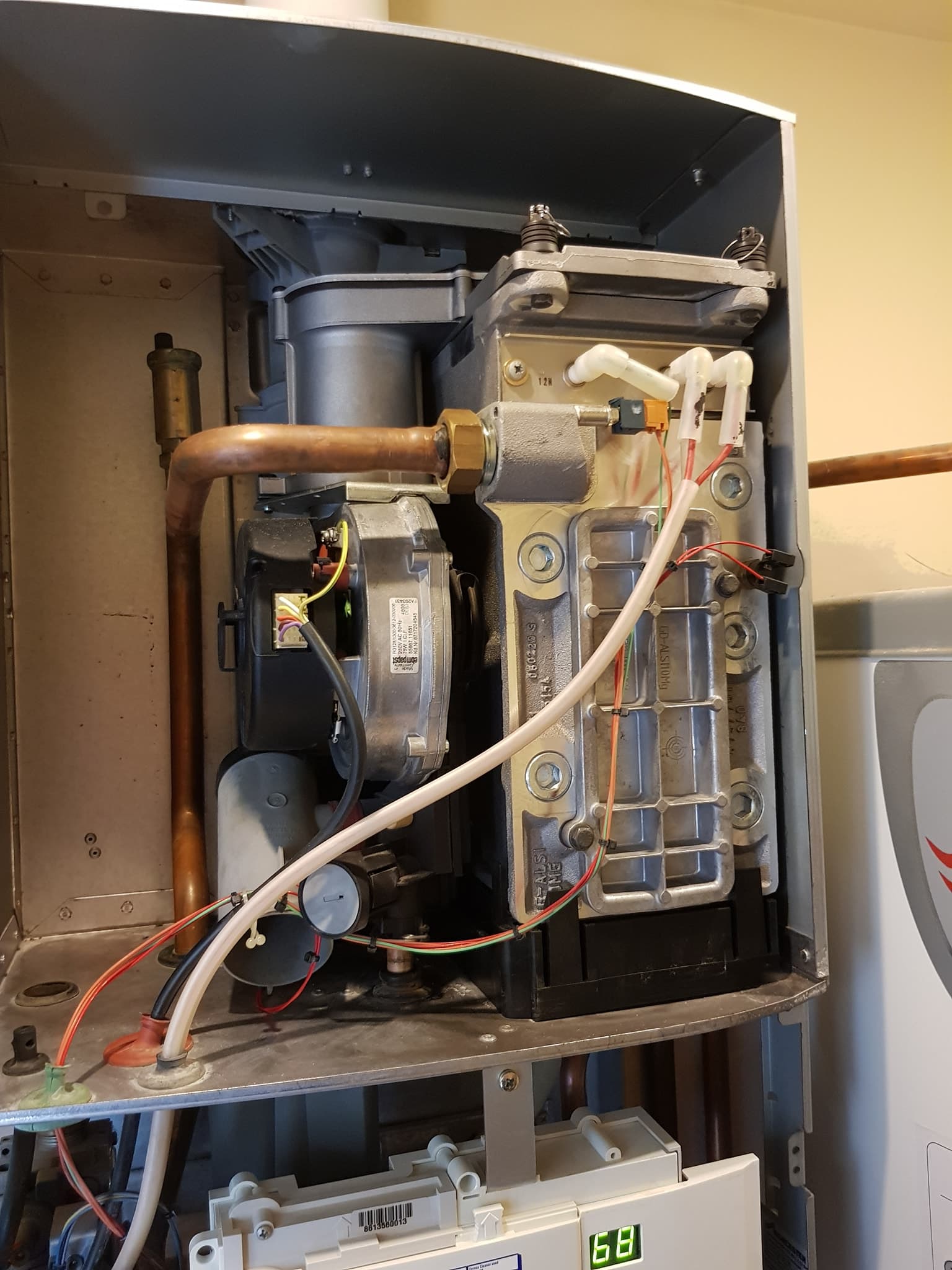 Open boiler showing internal components during a repair